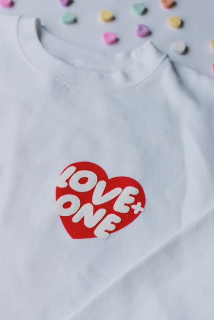 white crewneck with red and white Love One heart detail